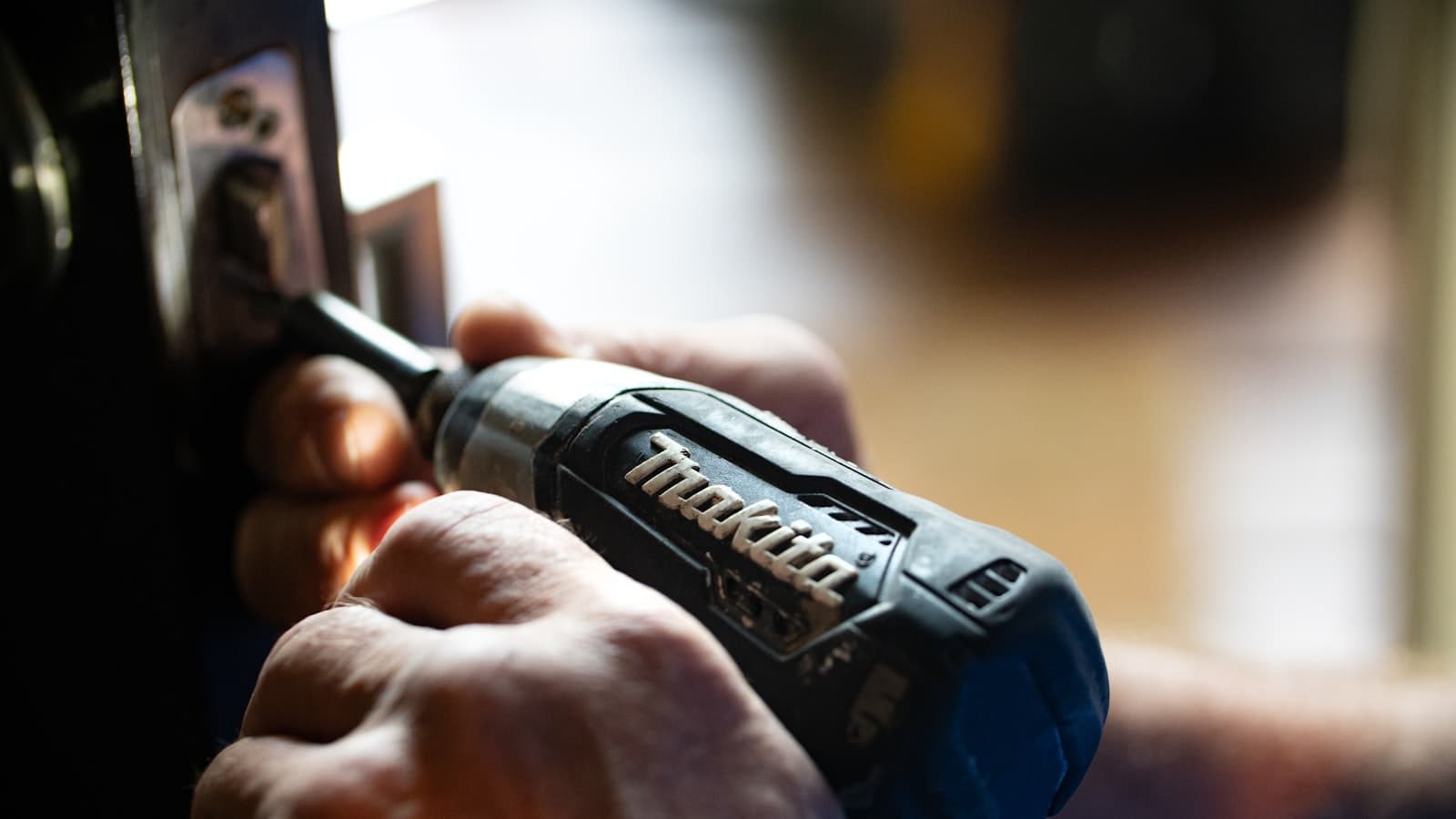Working on an electrical outlet with a screwdriver