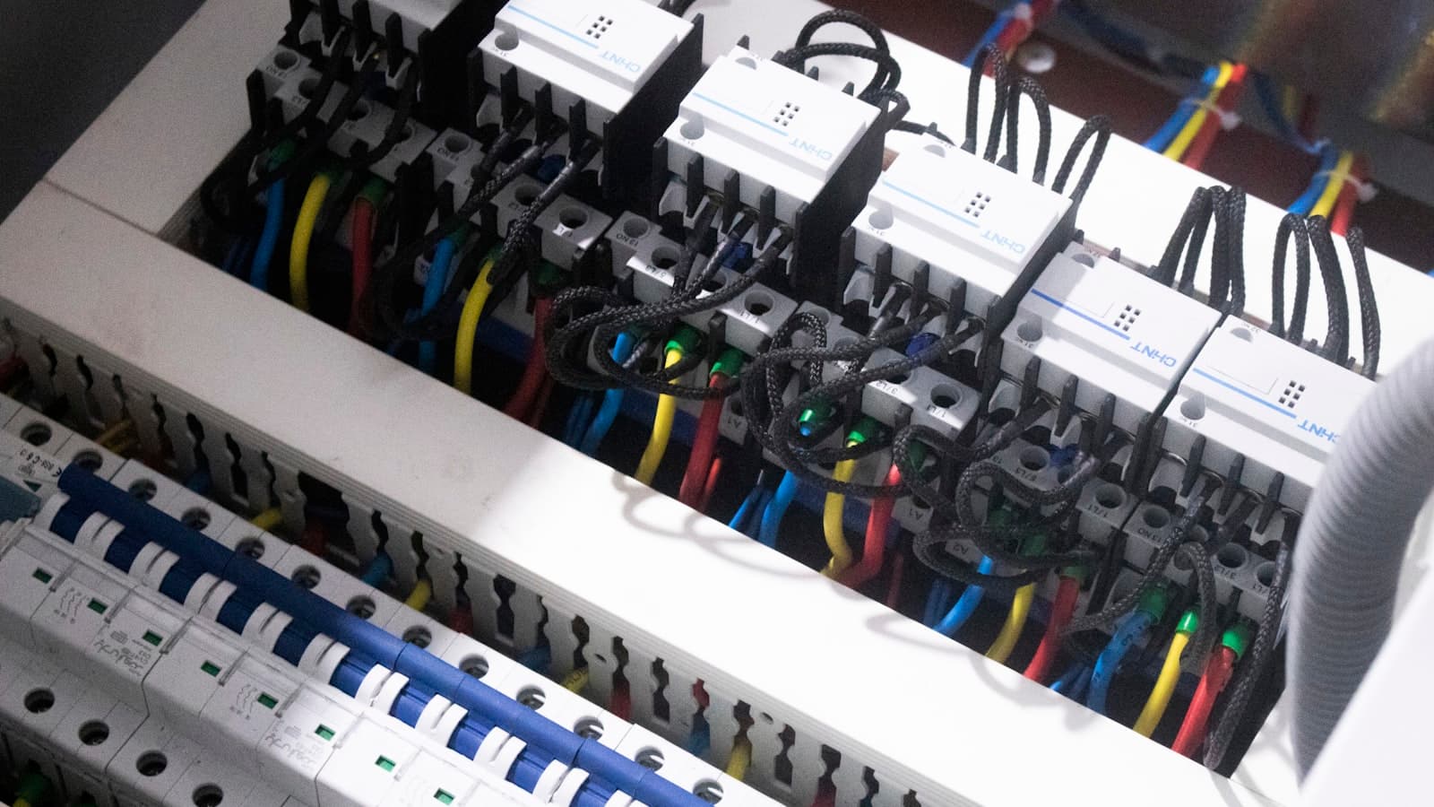 Open electrical breaker panel showing circuit breakers and wiring before a panel upgrade